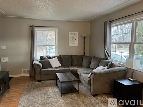 A living room with a grey couch and a coffee table.