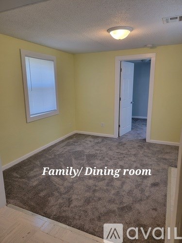 A room with yellow walls and a carpeted floor is labeled as a family dining room.