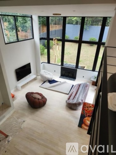 A living room with a fireplace and a large window.