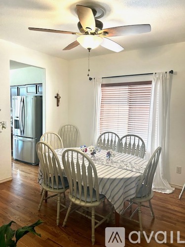 A dining room with a table set for four.