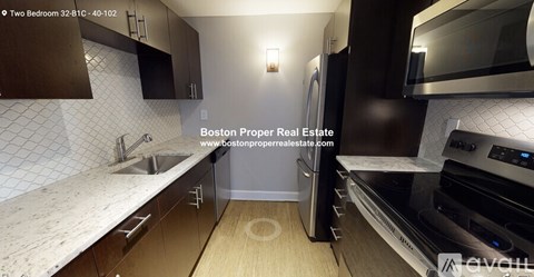 A modern kitchen with a sink, stove, and oven.
