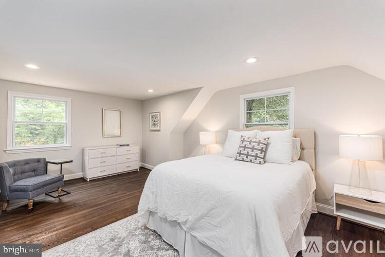 A bedroom with a large bed and a window.
