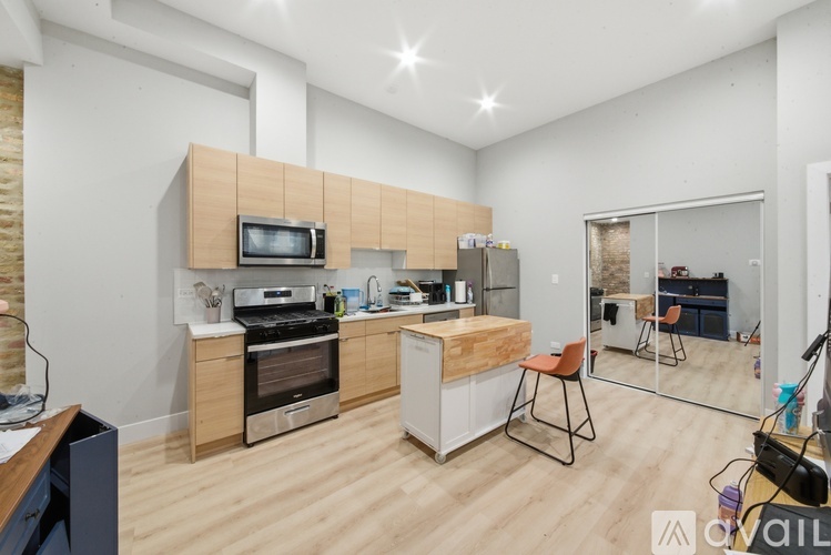 A kitchen with wooden cabinets and a brick wall.