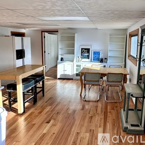 A kitchen with a table and chairs in the middle of the room.