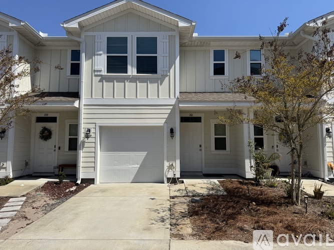 A two-story house with a white exterior and a garage.