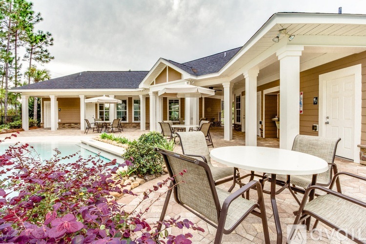 A house with a pool and patio furniture.