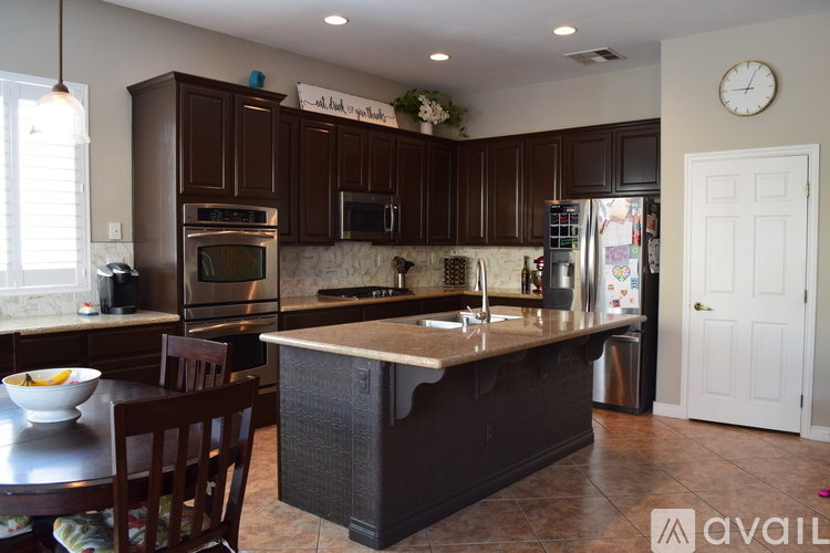 A kitchen with brown cabinets and a large island.