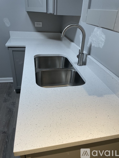 A kitchen sink with a faucet and a countertop.