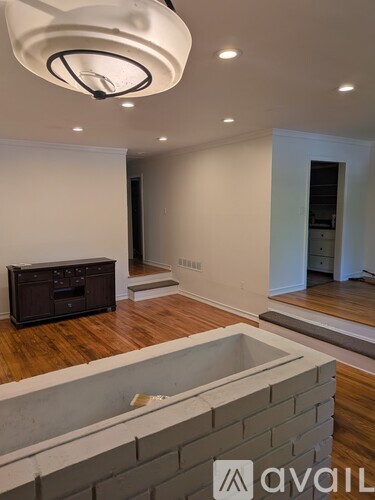A modern living room with a television and a fireplace.