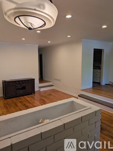 A modern living room with a television and a fireplace.