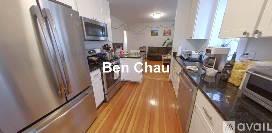 A kitchen with wooden floors and stainless steel appliances.