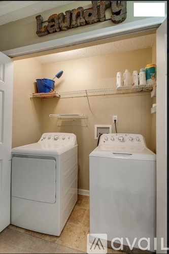 Two front load washing machines in a laundry room.
