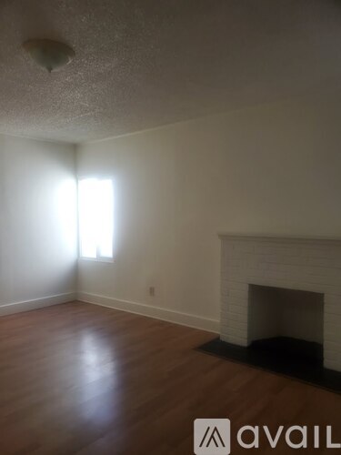 A room with a fireplace and a window.