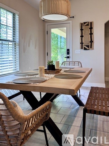 A dining room with a wooden table and chairs.