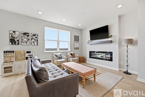 A living room with a brown leather couch and a wooden coffee table.