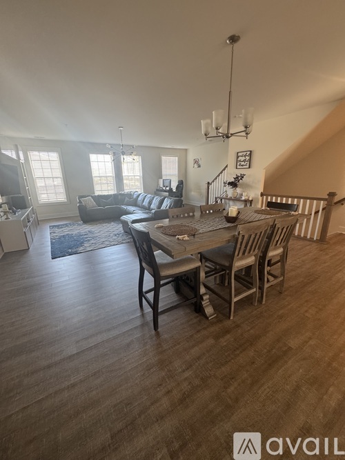 A dining room with a wooden table and chairs.