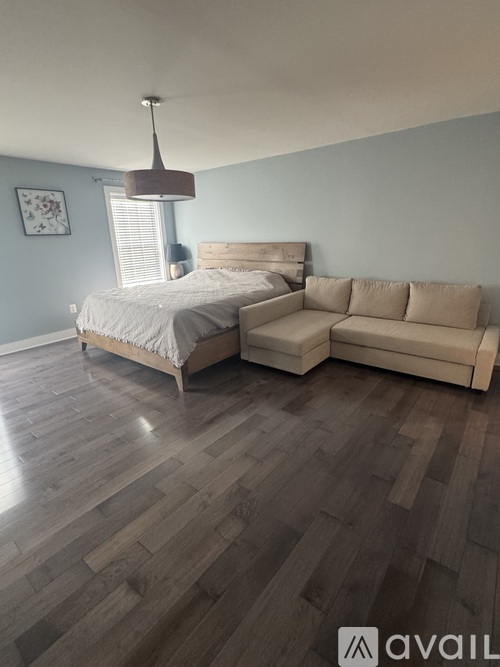 A bedroom with a bed and a couch.