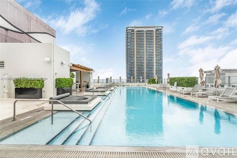 A large indoor swimming pool with a long lap pool and a diving board.
