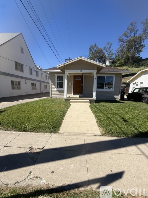 A house with a brown door and a small front yard.