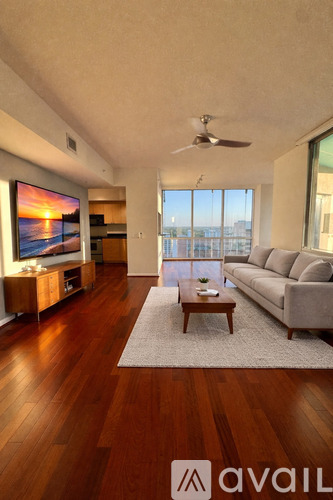 A living room with a flat screen TV and a couch.
