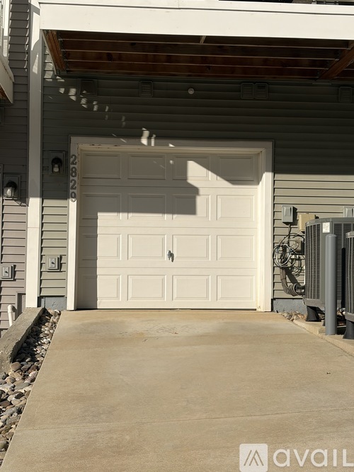 A white garage door with the number 28202 on it.