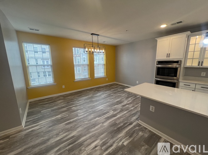 A kitchen with a grey countertop and a grey floor.