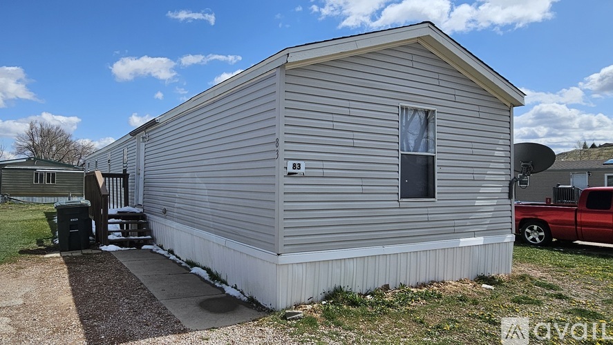 A grey house with the number 83 on it.