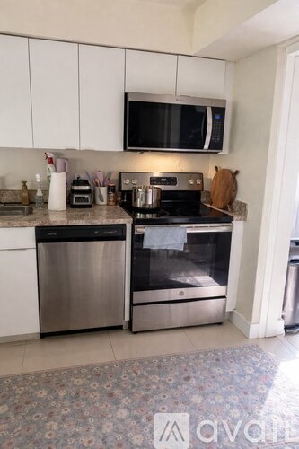 A kitchen with a stainless steel dishwasher and oven.