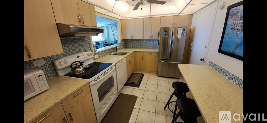 A kitchen with wooden cabinets and a tile floor.