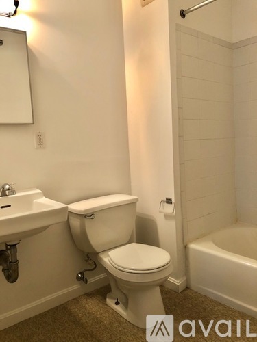 A white toilet sits next to a sink in a bathroom.