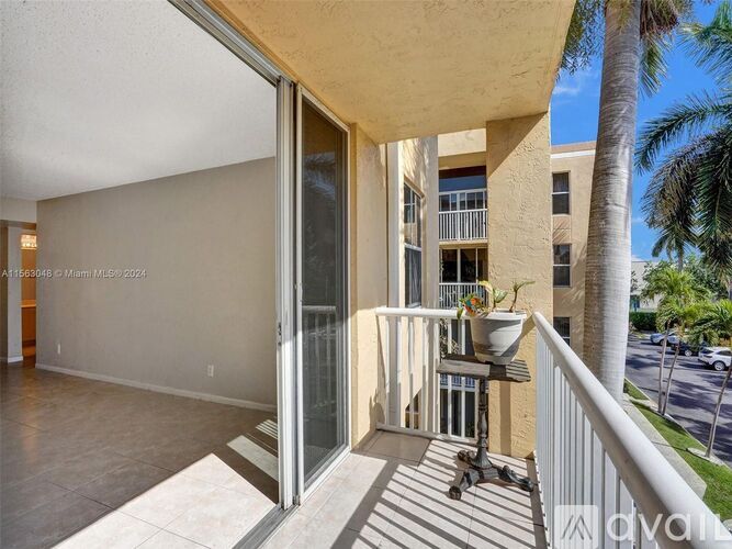 A balcony with a table and chairs is visible from the living room.