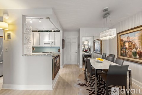 A modern kitchen with a dining table set for four.