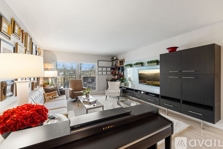 A modern living room with a piano in the foreground.
