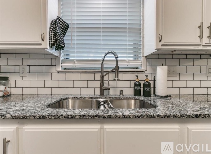 A kitchen with a sink and a window.