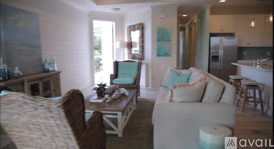 A living room with a couch, a chair, and a coffee table.