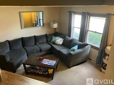 A living room with a grey sectional sofa and a coffee table.