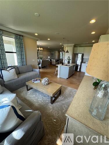 A living room with a grey couch and a coffee table.