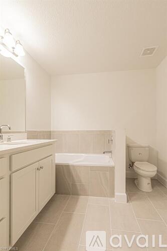 A bathroom with a toilet, sink, and bathtub.
