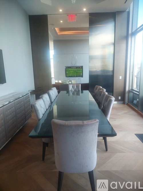 A conference room with a long table and chairs.