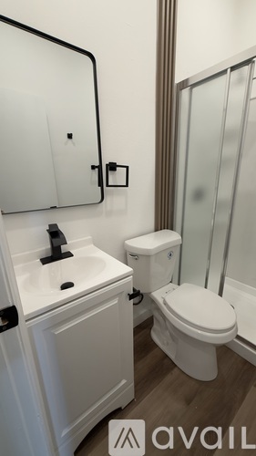 A white toilet sits next to a sink in a bathroom.