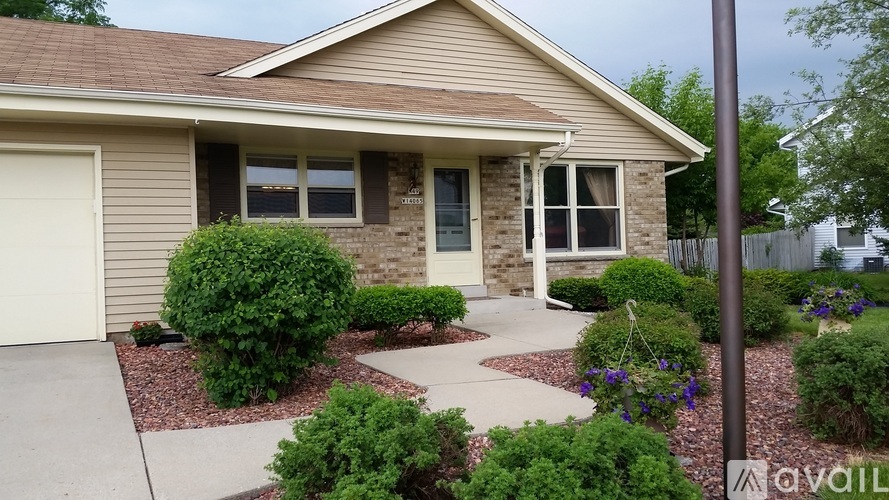 A house with a brown roof and a white garage door.