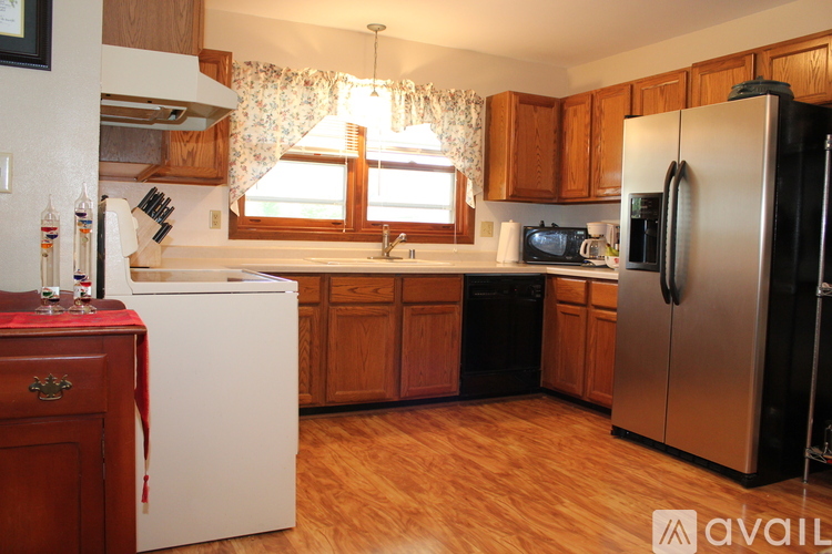 A kitchen with wooden cabinets and a white refrigerator.