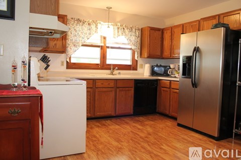 A kitchen with wooden cabinets and a white refrigerator.