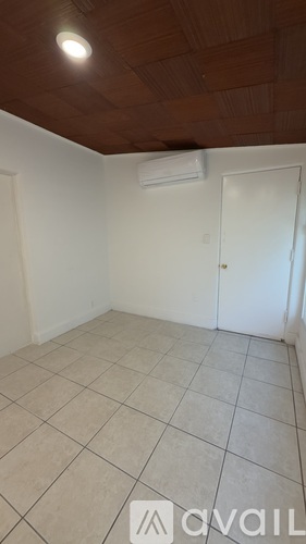 A room with a tiled floor and a ceiling fan.