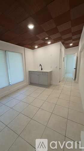 A room with a checkered ceiling and a white cabinet.