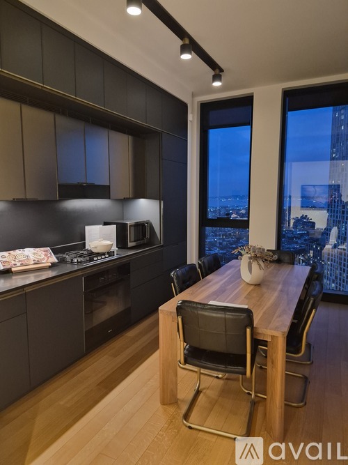 A modern kitchen with a dining table and chairs.