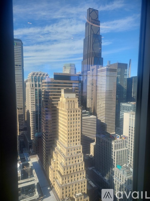 A cityscape with tall buildings and a clear sky.