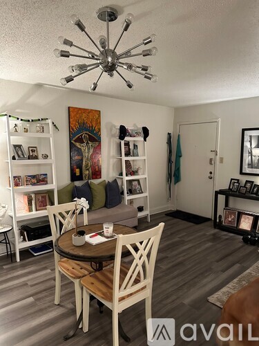 A dining room with a round table and chairs.