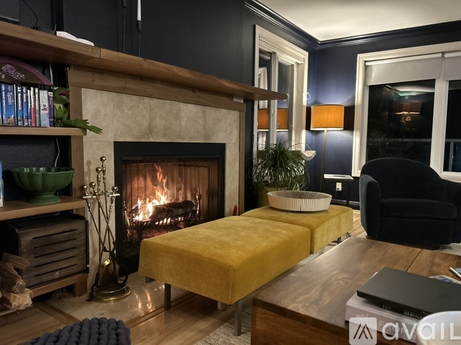 A cozy living room with a fireplace and a yellow couch.