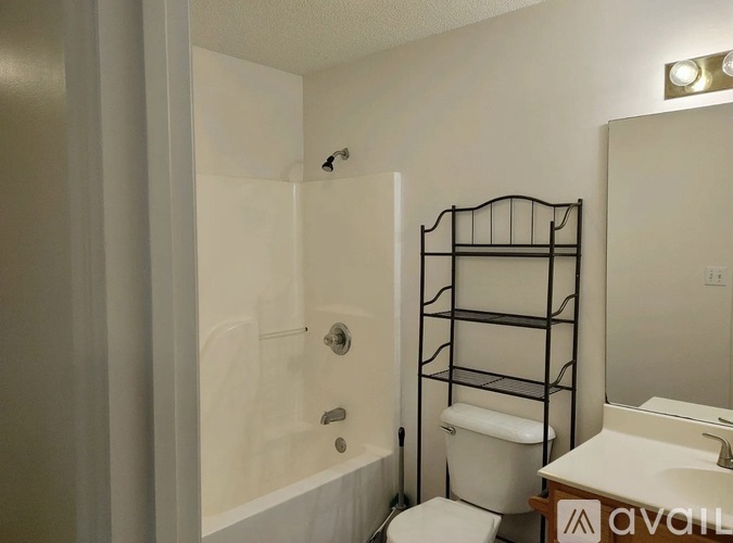 A bathroom with a toilet, sink, and bathtub.
